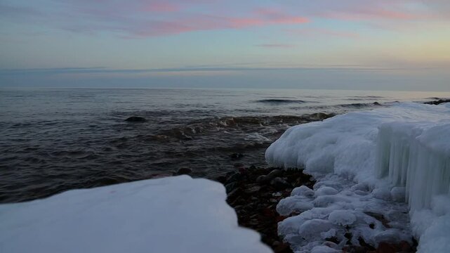 Icy winter sunset on lake superior shore, grand marais, minnesota