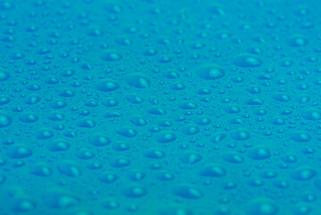 Blue plastic with water drops macro photo. Abstract blue background.