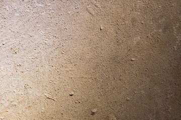 Image shows a textured surface, possibly concrete or composite material with gradient and soft shadows No other significant objects present
