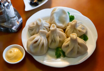 Appetizing khinkali on a plate closeup. Georgian cuisine