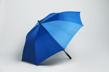 Open blank blue parasol for branding on light grey background. Mockup for design
