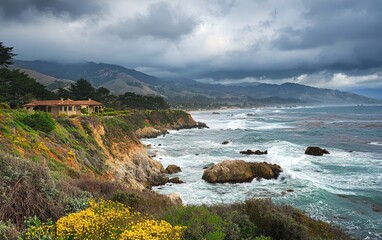 Obraz premium Scenic coastal view overlooking waves crashing on rocky shore near a charming house surrounded by greenery and wildflowers