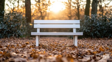 A white bench rests amid a vibrant field of colorful leaves.