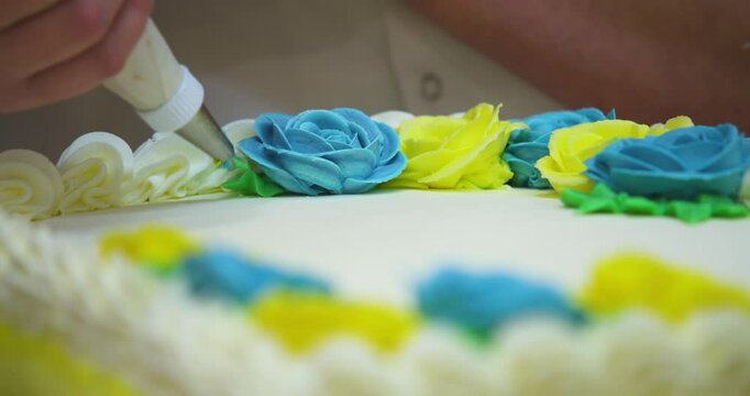 Close up of cake artist decorating a cake