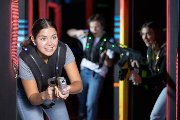 Young woman playing lasertag in arena