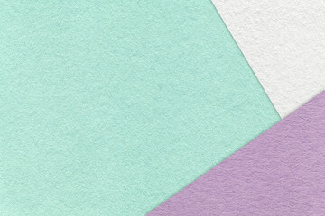 Fototapeta premium Texture of craft light green color paper background with white and purple border. Vintage abstract mint cardboard.
