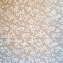 A textured wall featuring intricate floral designs in white, perfect for interior design projects, wallpapers, or backgrounds that evoke elegance and sophistication in home decor,