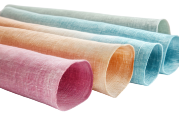 Soft, colorful linen fabrics rolled neatly, showcasing a variety of pastel shades for textile crafts