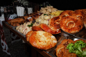 Varied assortment of hot delicious bakery and freshly baked goods. Selling food products at a street fair. Street food to go. Fast food. Traditional Ukrainian dishes of national cuisine. 