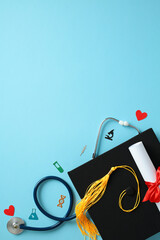 Medical graduation concept with stethoscope, graduation cap, diploma, and medical confetti on a...