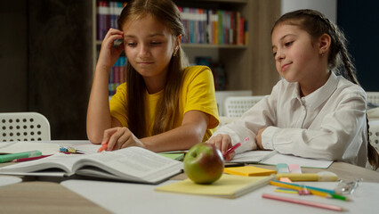 Sad little girls school education problem difficult task learn at classroom tired upset pupils students teens schoolgirls kids sisters children worried studying lesson reading book frustrated burnout