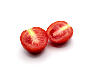 A halved of tomato sits against a clean white background