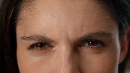 Extreme close-up view female dark human eyes Caucasian woman girl gaze staring looking front strong...