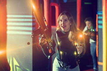 Young woman playing lasertag in arena