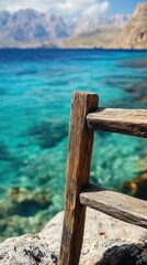Scenic View of Crystal-Clear Ocean Water with a Rustic Wooden Rail Overlooking a Serene Coastal Landscape in a Picturesque Mountainous Region