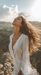 A confident young woman in white clothes, standing on top of a mountain, wind blowing in her hair, feeling free and powerful, cinematic lighting 