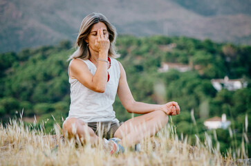Woman practicing breathing exercises in nature
