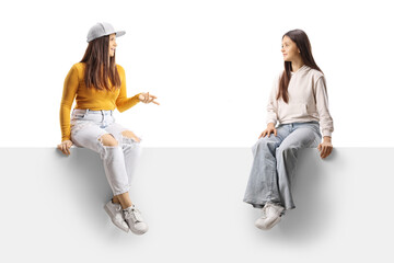 Teenage girls sitting on a panel and talking
