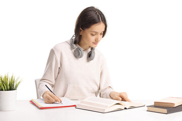 Teenage female student studying on a desk