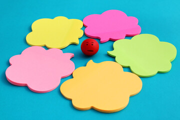 Sphere with facial expression surrounded by several comment bubbles