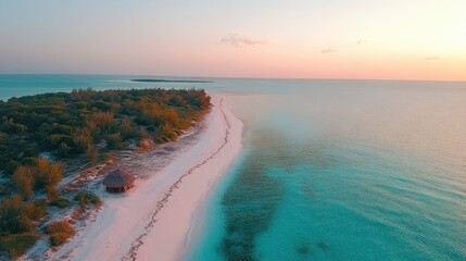 Serene aerial view of a tropical beach at sunset, showcasing soft sands, gentle waves, and lush greenery
