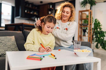 Mother and daughter drawing together on mother's day