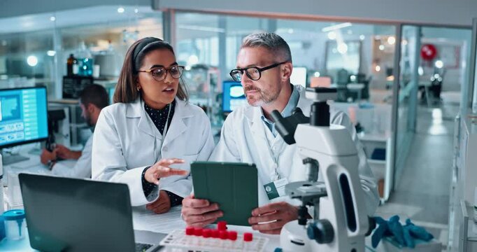 Scientist, people and laptop with tablet in discussion for chemistry, testing and medical research. Biotech, laboratory and mentor with study assistant for pharmaceutical data or pathology experiment