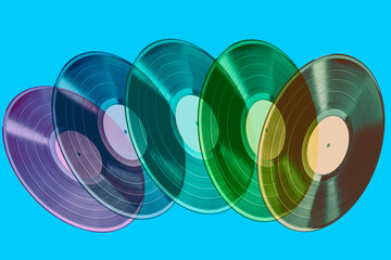 Colorful transparent vinyl records in motion on blue background