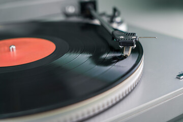 Close-up of turntable needle on spinning vinyl record
