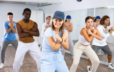 Fototapeta premium Group of positive dancers repeat dance in dance hall