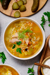 Traditional Russian rassolnik soup with pork and pickles .style rustic