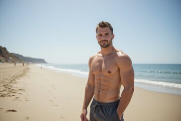 Fit young Caucasian man enjoying a sunny day at the beach, showcasing a toned body with defined muscles and an effortlessly confident demeanor near the ocean.