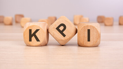 wooden blocks spelling KPI symbolizing key performance indicators, business metrics, and success tracking