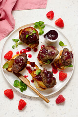 Crostini with chicken liver, caramelized pear and raspberry sauce.top veiw