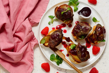 Crostini with chicken liver, caramelized pear and raspberry sauce.top veiw