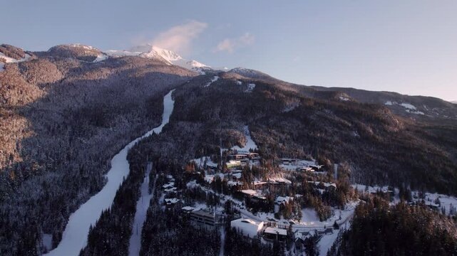 Alpine homes on hill at sunset, Whistler Mountain, aerial footage, winter scene, log cabin, luxury vacation home, mountain home. 4K 24FPS