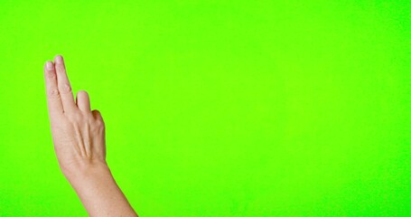 Female Hand Swiping Back and Forth on Chroma Key Green Screen.
