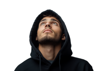 Young man wearing a hooded sweatshirt looking up against a plain background