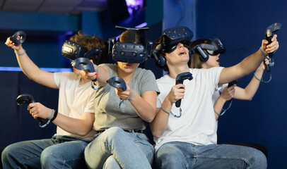 Young people having fun with new technology of a vr headset goggles