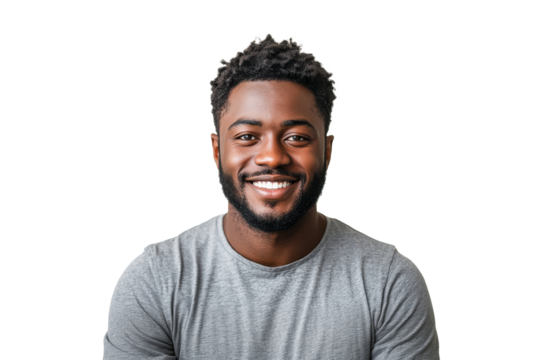 Young man smiling confidently in casual attire with a neutral background