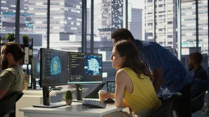 Employee using AI technology to design algorithms that enable machines to learn from data. Admin in office training large scale deep learning models with artificial intelligence tech, camera B © DC Studio