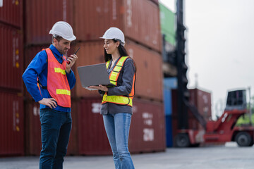 Two logistics workers man and woman discuss operations at a busy shipping container yard. successful coordination in freight, transportation, and supply chain operations