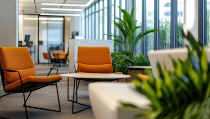 Fototapeta premium Modern office lounge area with orange chairs, a small table, and plants.