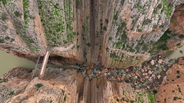 Caminito del Rey in Garganta Gorge, del Chorro, Spain. Aerial shot of a bridge in a narrow gorge, a river flows below. 