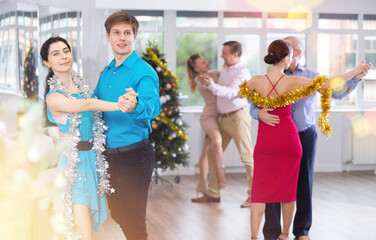 Young couple rehearsing and dancing in dance class