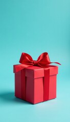 Fototapeta premium Open red gift box with red bow, pastel blue background Valentine's/birthday gift , romance, special occasion