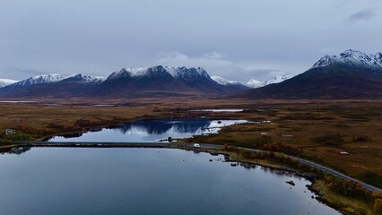 Motorhome Parked at Serene lake and river surrounded by fjord majestic mountains with a beautiful sky and calm reflections in norway
