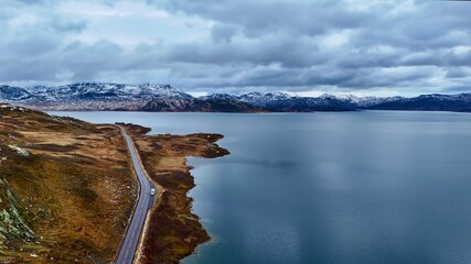 Motorhome Parked at Serene lake and river surrounded by fjord majestic mountains with a beautiful sky and calm reflections in norway