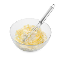 Bowl and whisk with delicious cream isolated on white