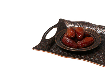 Dried dates in a bronze authentic dishes set, space for text, isolated on white background, PNG
